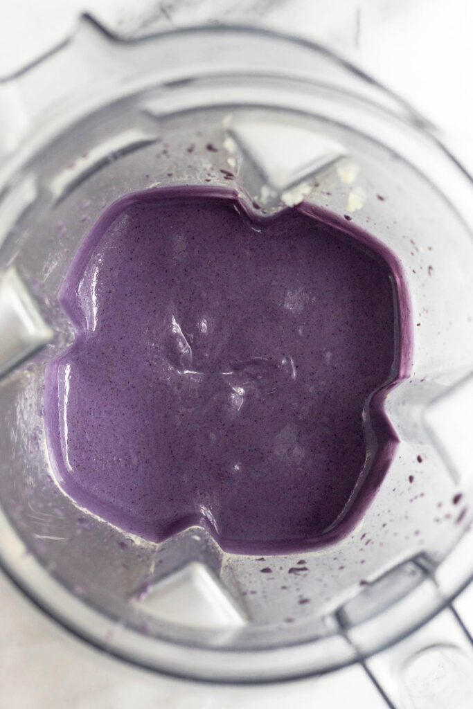 Blender with a healthy blueberry smoothie in it.