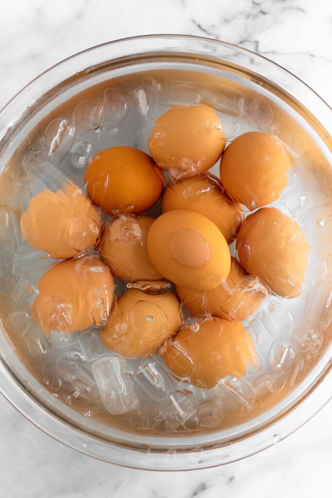 A large bowl with eggs in an ice bath.