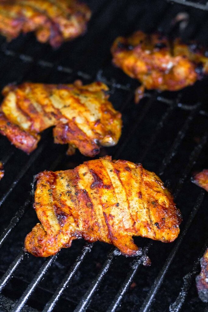 Chipotle grilled chicken thighs on a grill.