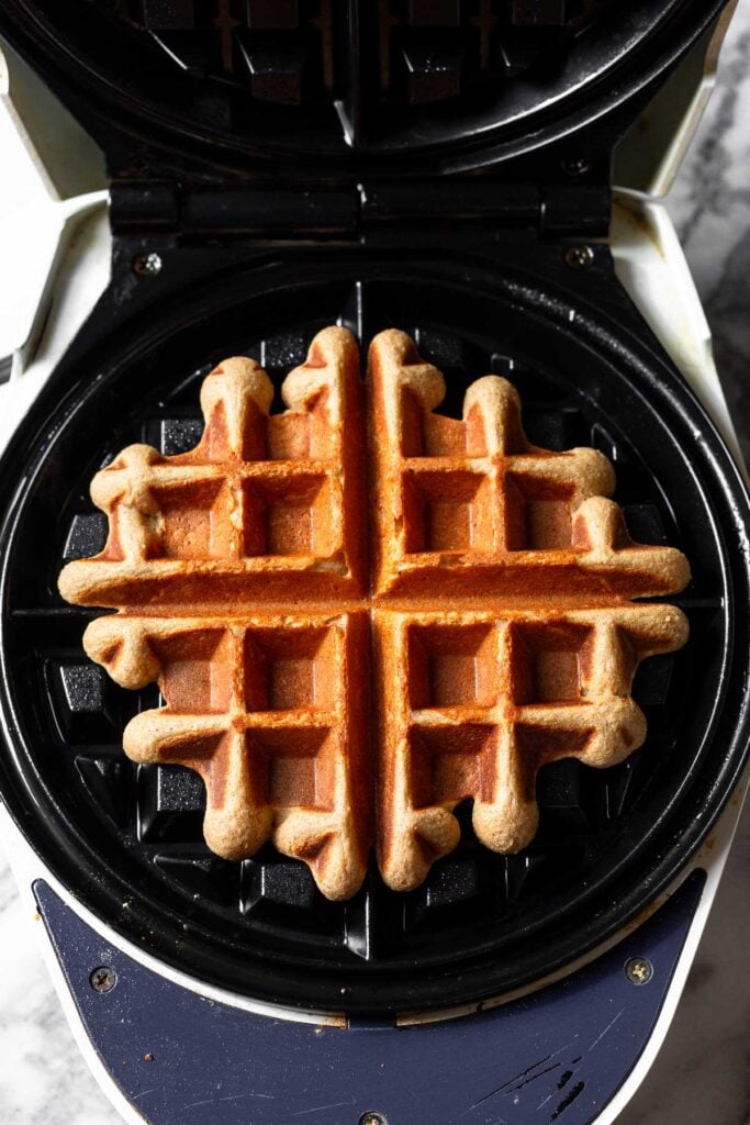 Cooked waffle in waffle maker.