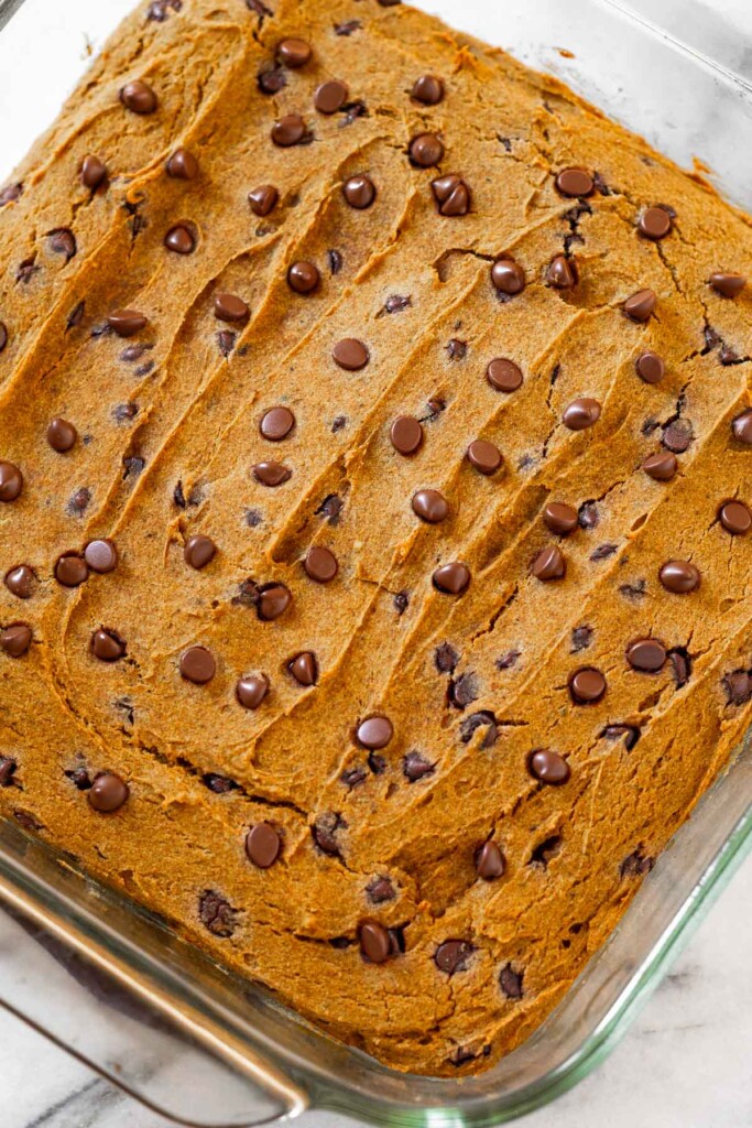 Overhead shot of chocolate chip pumpkin bars in a glass baking pan.