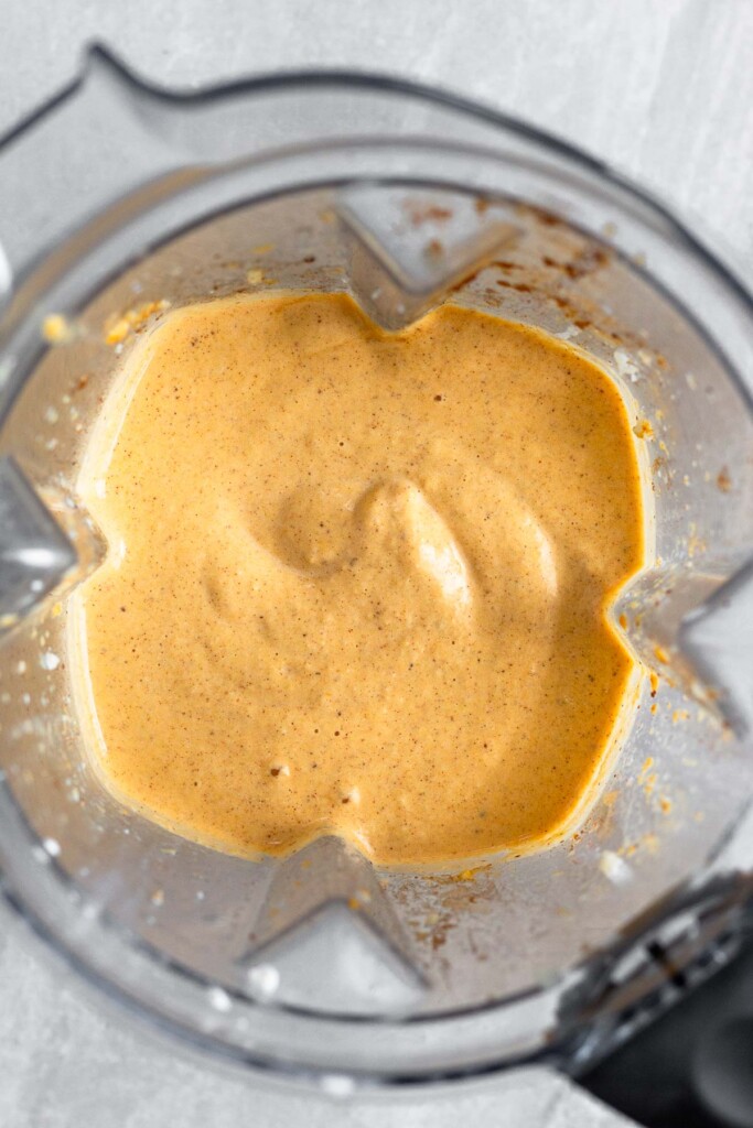 Overhead shot of a thick sweet potato smoothie in a blender.