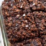 Close up of brownie baked oatmeal in a baking dish cut into squares.