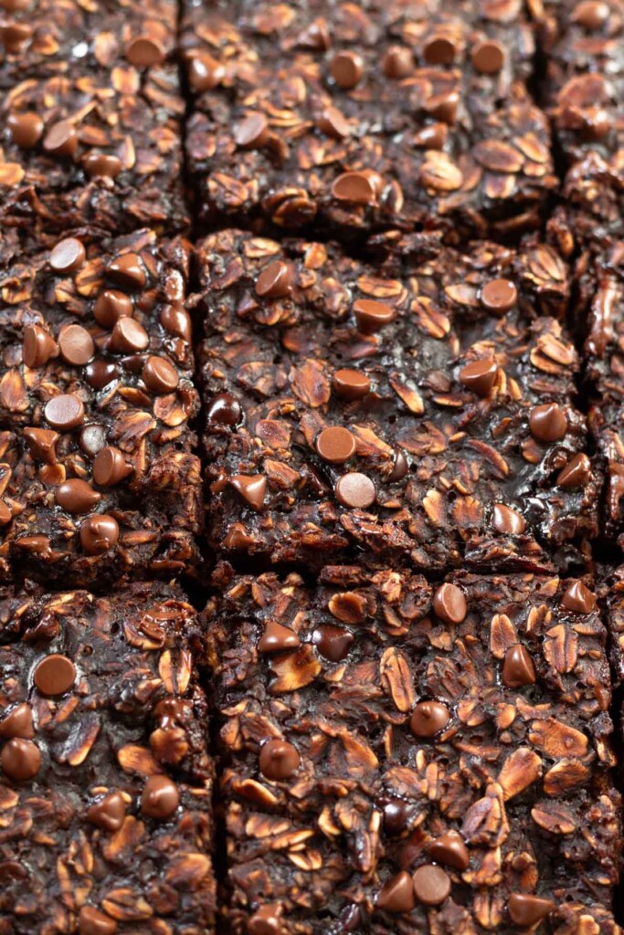 Close up of chocolate baked oatmeal with chocolate chips sliced into equal squares.