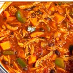 Chicken sweet potato soup with black beans and peppers in a large dutch oven.