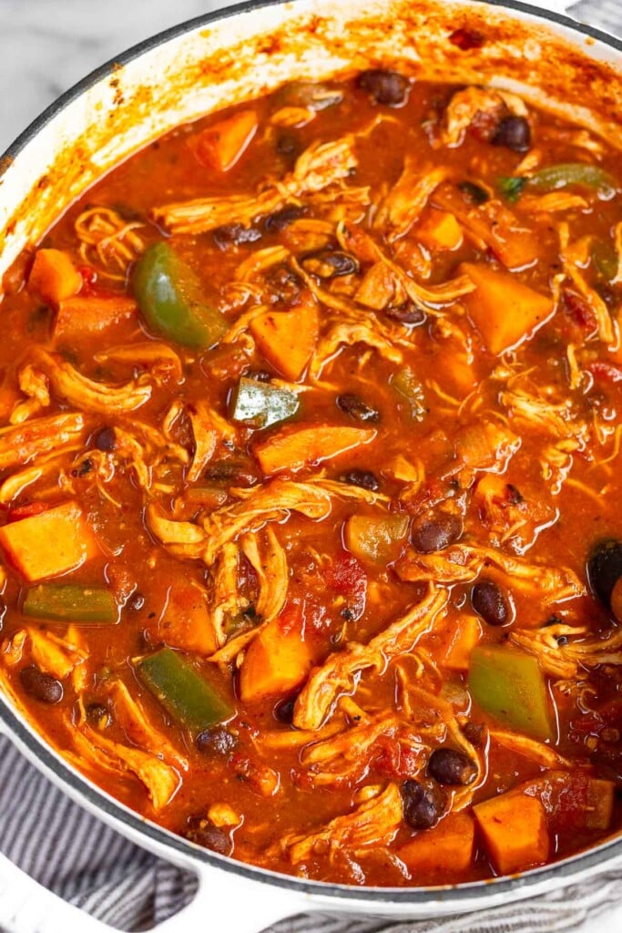 Sweet potato chicken soup with black beans and peppers in a large dutch oven.
