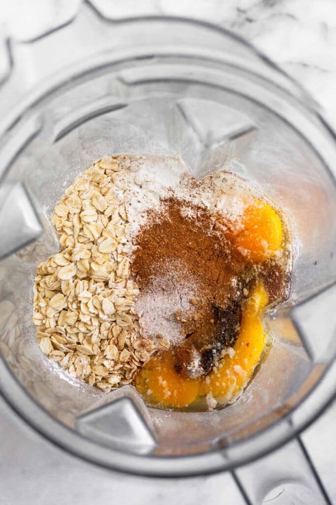 Blender with cottage cheese, rolled oats, eggs, baking powder, spices, and salt.