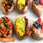 A baking sheet with 6 stuffed breakfast sweet potatoes. Two are stuffed with sausage, peppers, and kale, two are stuffed with bacon, eggs, and avocado, and two are stuffed with fruit and nut butter.