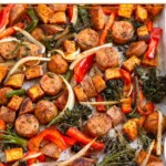 Sheet pan sausage and veggies with peppers, onions, broccoli, and potatoes.