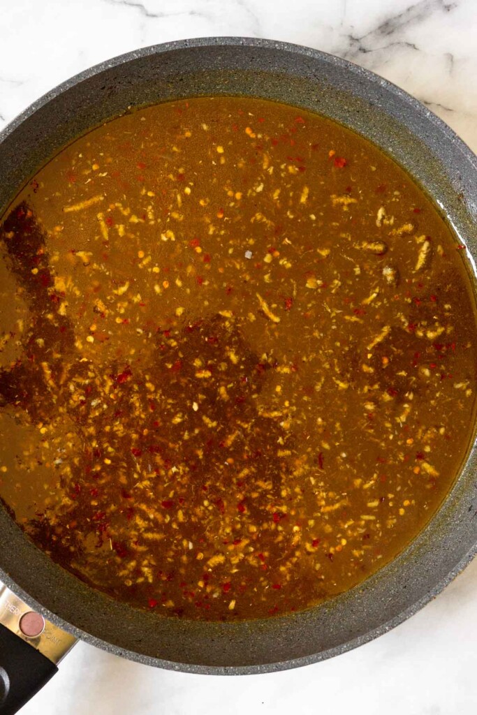 Large skillet filled with stir fry sauce.