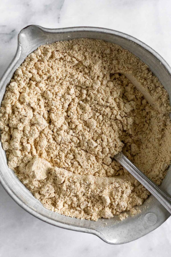 An overhead shot of a bowl with flour and spices mixed together. A fork is also in it.