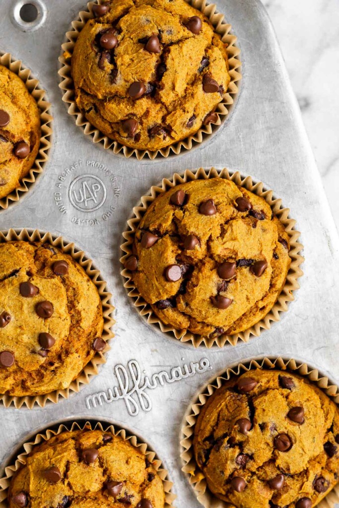 Overhead shot of healthy pumpkin muffins with chocolate chips in a muffin tin.