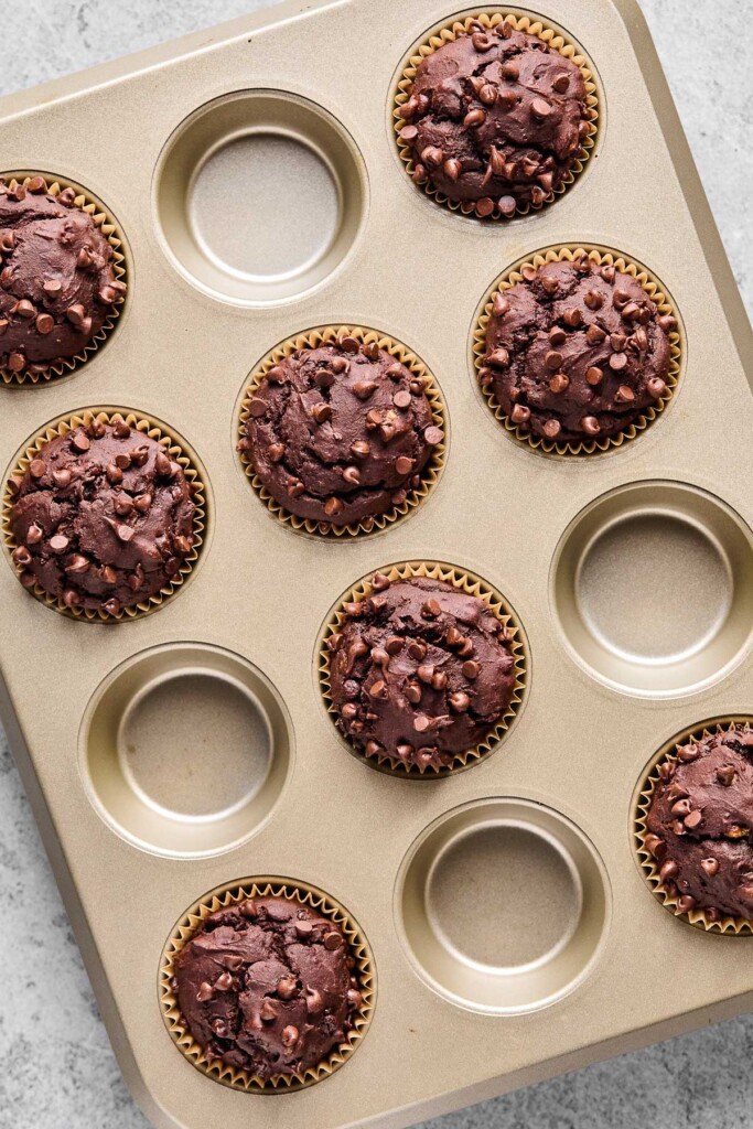 Overhead shot of protein chocolate muffins in a muffin tin.