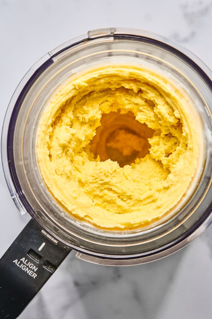 Mango frozen yogurt in a Ninja Creami container.