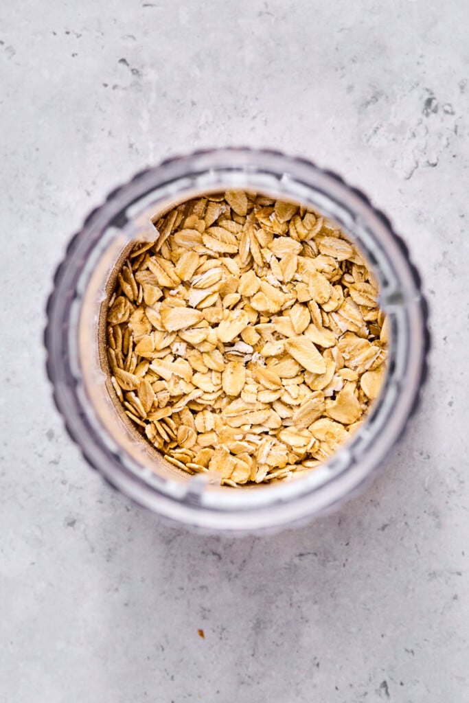 Small jar blender filled with rolled oats.
