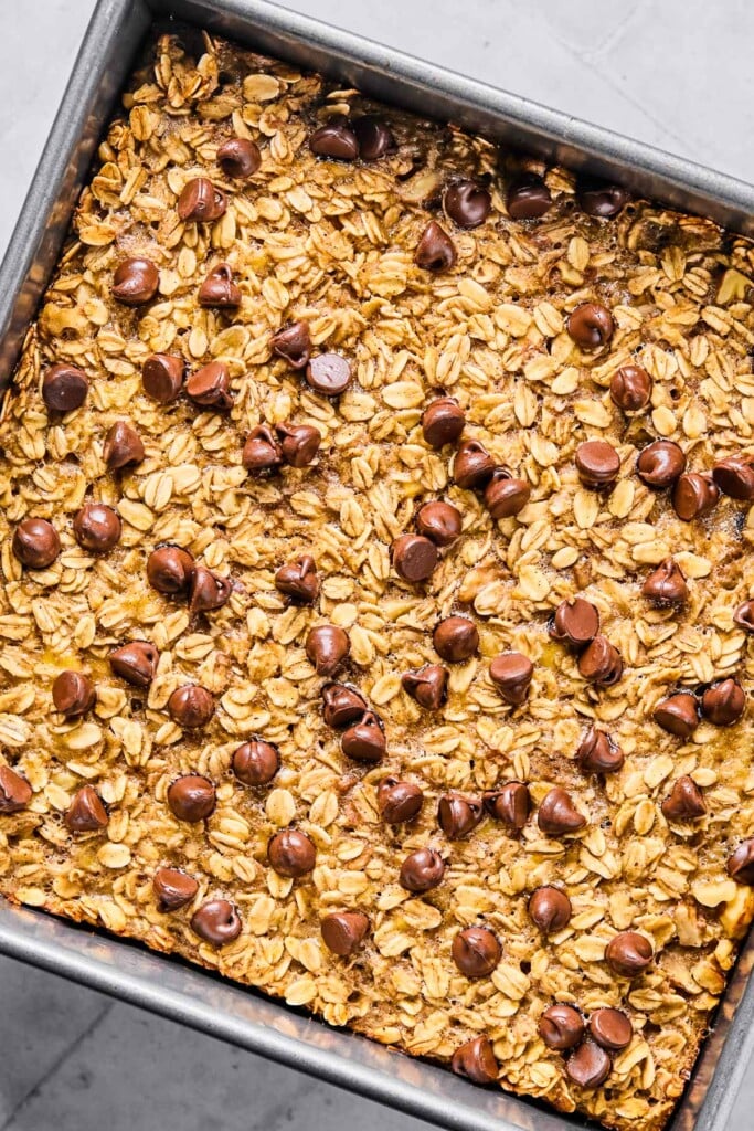 Baked banana oatmeal with chocolate chips in a baking pan.