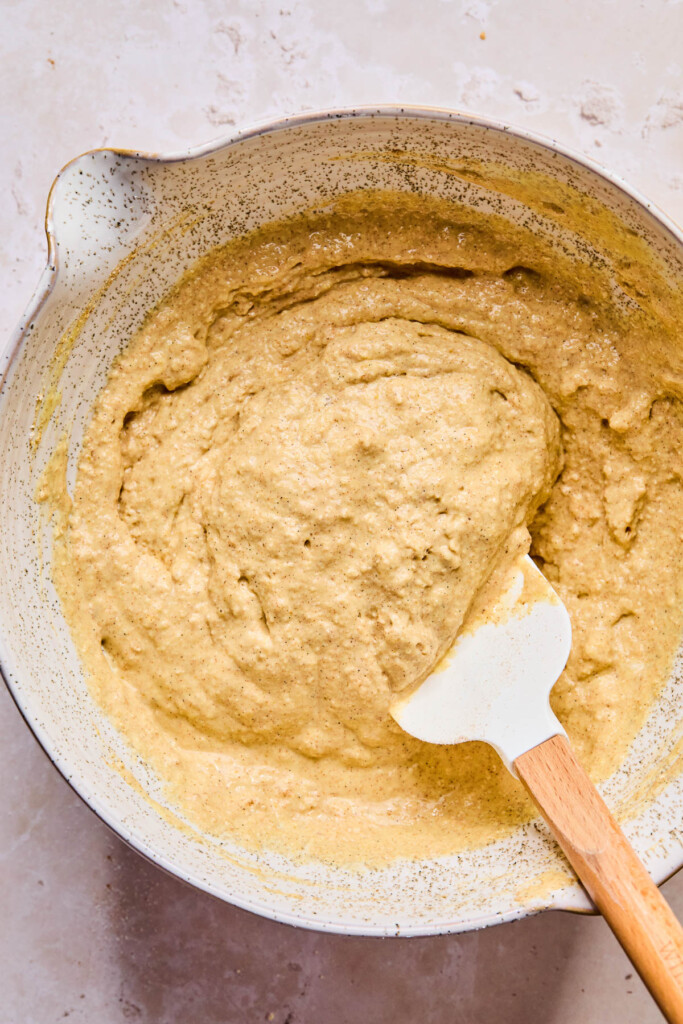 A bowl with a spatula with pancake batter with yogurt in it.